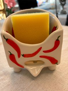 a yellow sponge in a white bowl on a table