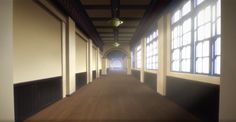 an empty hallway with large windows and wooden floors