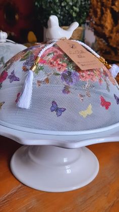 a cake with butterflies on it sitting on top of a table