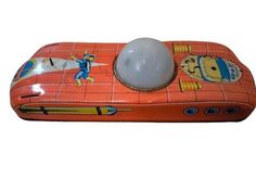 an orange and white object with cartoon characters on it's sides, including a ball