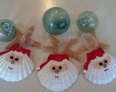 three seashells with santa claus's face on them