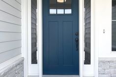 a blue front door on a white house