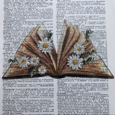 an open book with daisies and leaves on it, sitting on top of a page