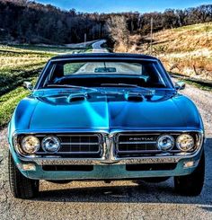 a blue car parked on the side of a road