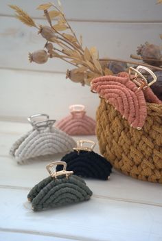 four pairs of earrings sitting on top of a basket