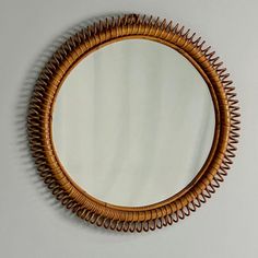 a round mirror hanging on the wall