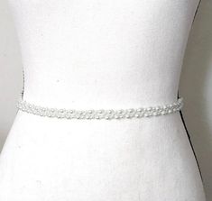 Enhance the elegance of your wedding gown with our exquisite pearl belt. Crafted with meticulous attention to detail, this beaded accessory adds a touch of sophistication to your bridal ensemble. Designed and handcrafted by ©JazzyAndGlitzy, it exudes charm and uniqueness, elevating your bridal look effortlessly. DETAILS: Handcrafted by ©JazzyAndGlitzy Features white pearls and ivory-toned ribbon Customizable lengths with ample ribbon on each side Welcome to custom orders and matching pieces HELP Belt For Wedding Dress, Wedding Dress Pearl, Beaded Bridal Sash, Accessories For Bride, Belt Wedding Dress, Wedding Accessories For Bride, Pearl Belt, Dress Pearl, Wedding Belt