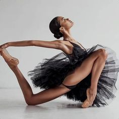 a woman in a black and white dress is dancing