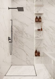 a bathroom with white marble walls and flooring, including shelves on the wall above the shower