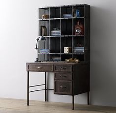 an old desk and bookcase in the corner of a room