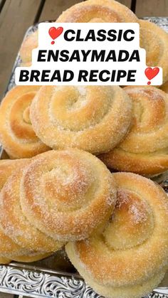 some bread rolls sitting on top of a metal tray with the words classic ensaymda bread recipe