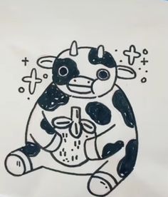 a black and white drawing of a cow sitting on top of a piece of paper