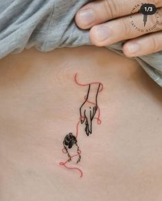 a woman with a tattoo on her stomach holding a dog's paw and tail