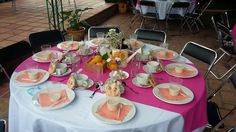 the table is set with pink and white plates