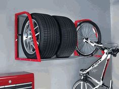 there is a bike on the wall with wheels attached to it and a toolbox underneath