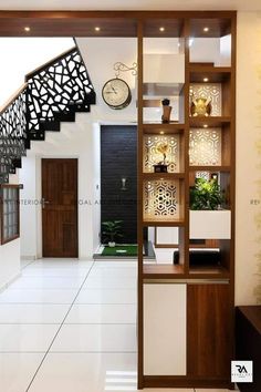 the interior of a modern house with stairs and decorative wall panels on the walls, along with a clock