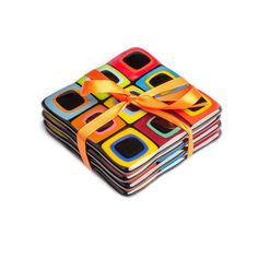 a stack of multicolored coasters with a yellow ribbon