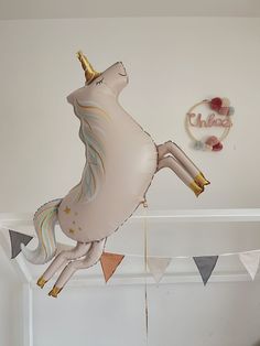 a balloon shaped like a unicorn flying through the air