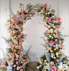 an arch made out of flowers and greenery