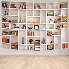 a white book shelf filled with lots of books on top of a hard wood floor