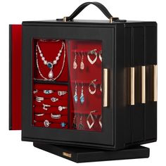 an open black box with jewelry inside on a white background and red lining around the bottom