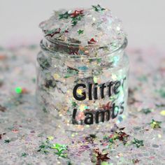 a jar filled with glitter sitting on top of a table