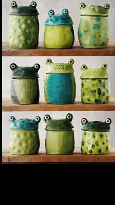 some green and blue pots are sitting on the wooden shelf with their lids open to look like they're covered in googly eyes