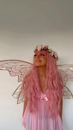 a woman with pink hair wearing a fairy costume