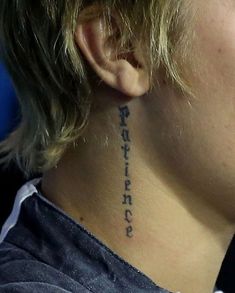 a woman with a small tattoo on her neck