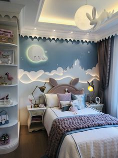 a bedroom decorated in blue and white with a whale mural on the wall above the bed