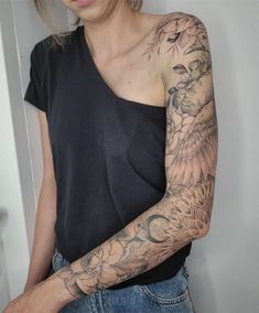 a woman with tattoos on her arm and shoulder