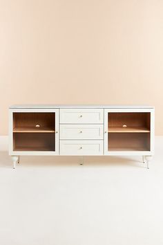 a white entertainment center with two drawers