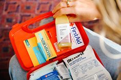 a person holding an open first aid kit