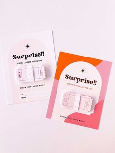 two pins with the words surprise written on them next to an advertiser's brochure