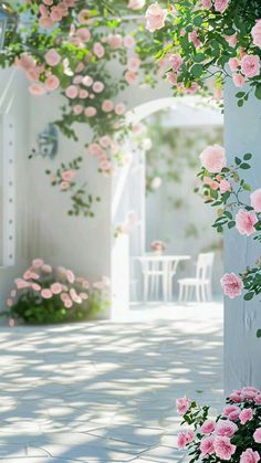 pink roses are growing on the side of a white building with an arch in the background