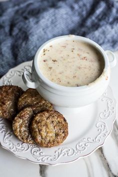 a white plate topped with cookies next to a bowl of soup