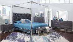 a bedroom with a canopy bed, dressers and mirror on the wall above it