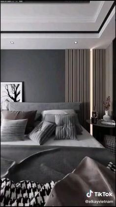 a large bed sitting in a bedroom next to a wall mounted painting on the wall