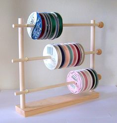 there are many different types of spools on the rack and one is empty