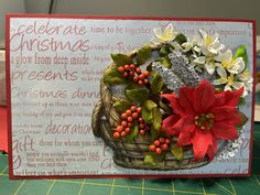 a christmas card with poinsettis and holly in a basket on a table