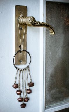 a door handle with beads hanging from it