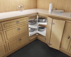 an open cabinet with pots and pans in it