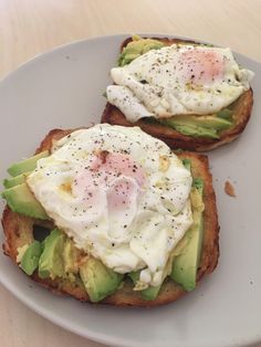 two pieces of toast topped with an egg and avocado