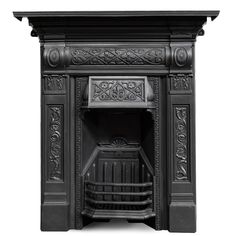 an ornate black fireplace with carvings on it