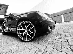 a black sports car parked in front of a building