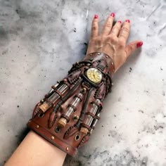 This steampunk brown cuff was made to order for a cosplay event. We created it from scratch.  The watch used in the design will be replaced by something similar because we had only one piece.   The bracelet was made of genuine cow leather and decorated with glass vials and various metal parts following the steampunk style.  The bracelet's width is about 20 cm (7.9 in) It can be personalized to your size. So, please leave your measurements at the checkout. Please measure your wrist to get the proper fitting item. CARE No special care is required. Avoid chemical exposure including perfumery. If you need a custom order please let me know and I will try to do my best to prepare it for you:) If you have any questions feel free to ask.  Thank you for choosing shop Steampunk Wrist Cuffs, Diy Steampunk Accessories, Artificer Homebrew, Fantasy Relics, Leather Vampire, Steampunk Apocalypse, Dnd Characters Art, Dnd Artificer, Dark Steampunk