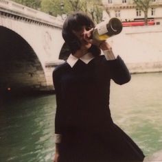 a woman talking on a cell phone while holding a megaphone to her ear