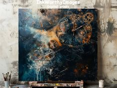 an abstract painting with gold and blue gears on it, in front of a white brick wall