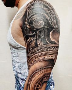 a man's arm with an egyptian tattoo on it