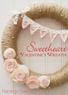 a valentine's wreath with pink flowers and bunting on the front door, says sweet heart valentine's wreath